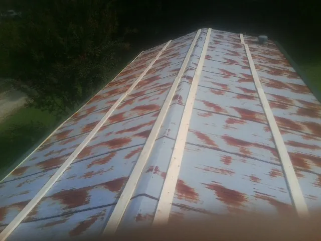Rusted metal roof panels with new wood purlins before replacement — Storm Damage Roof Repair in Solana Beach by Roofing Brothers